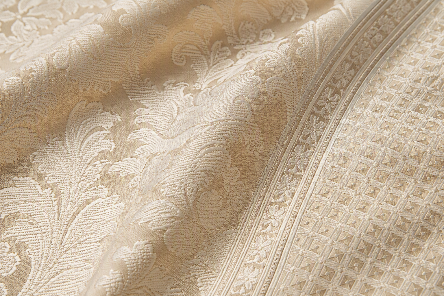 Close-up of jacquard tablecloth patterns: damask floral, geometric lattice and border