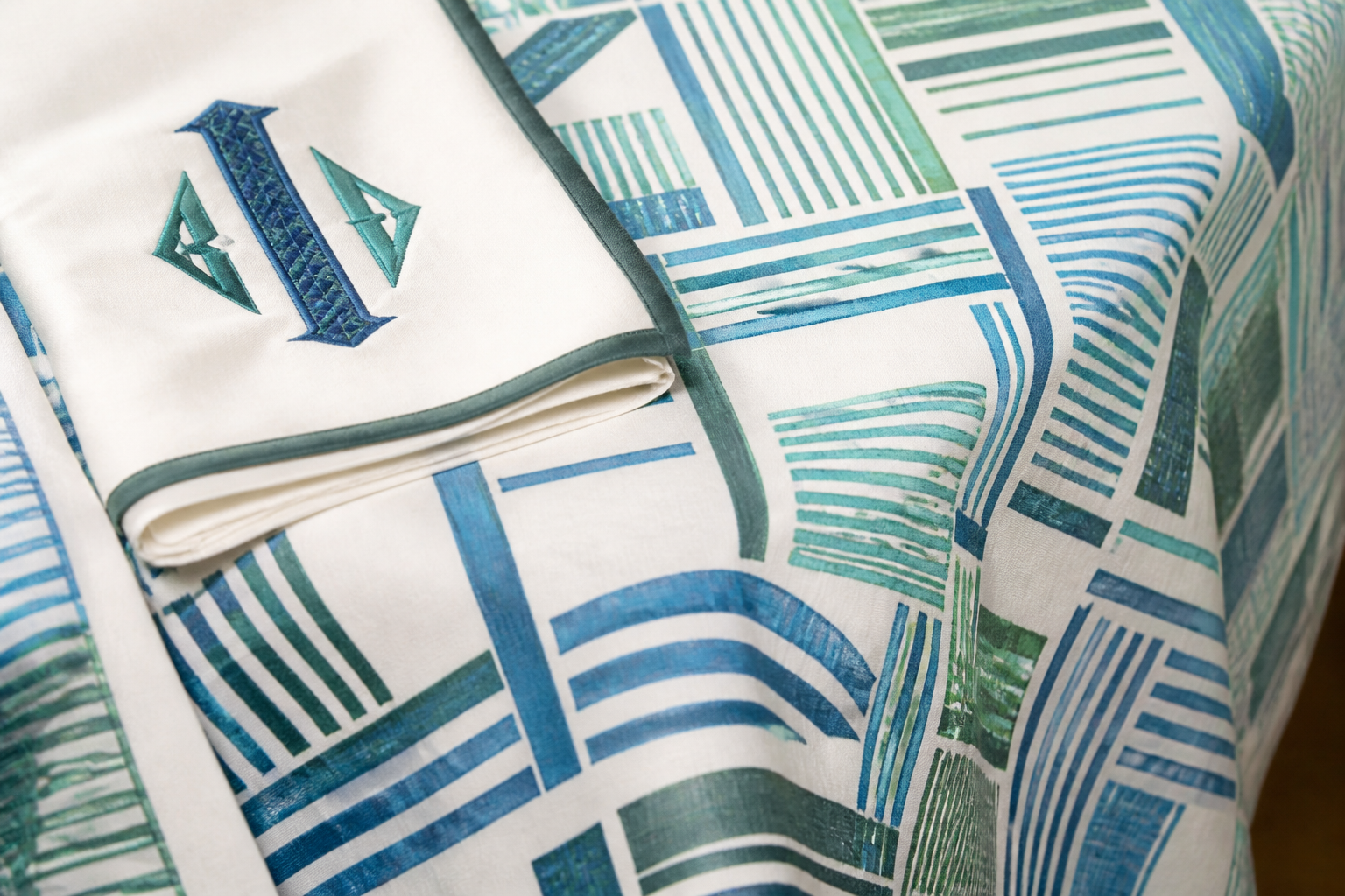 Custom printed tablecloth with geometric pattern and monogrammed napkin