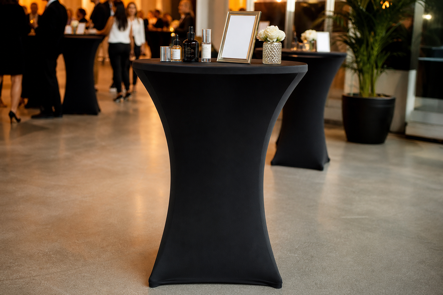 Stretch table cover fitted tightly over a tall cocktail table in black fabric