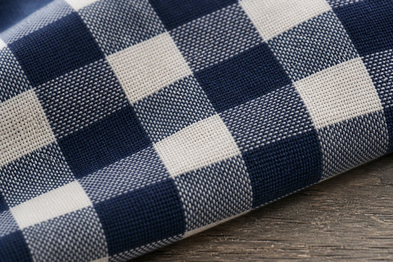 Close-up of yarn-dyed woven check fabric showing crisp intersecting woven threads