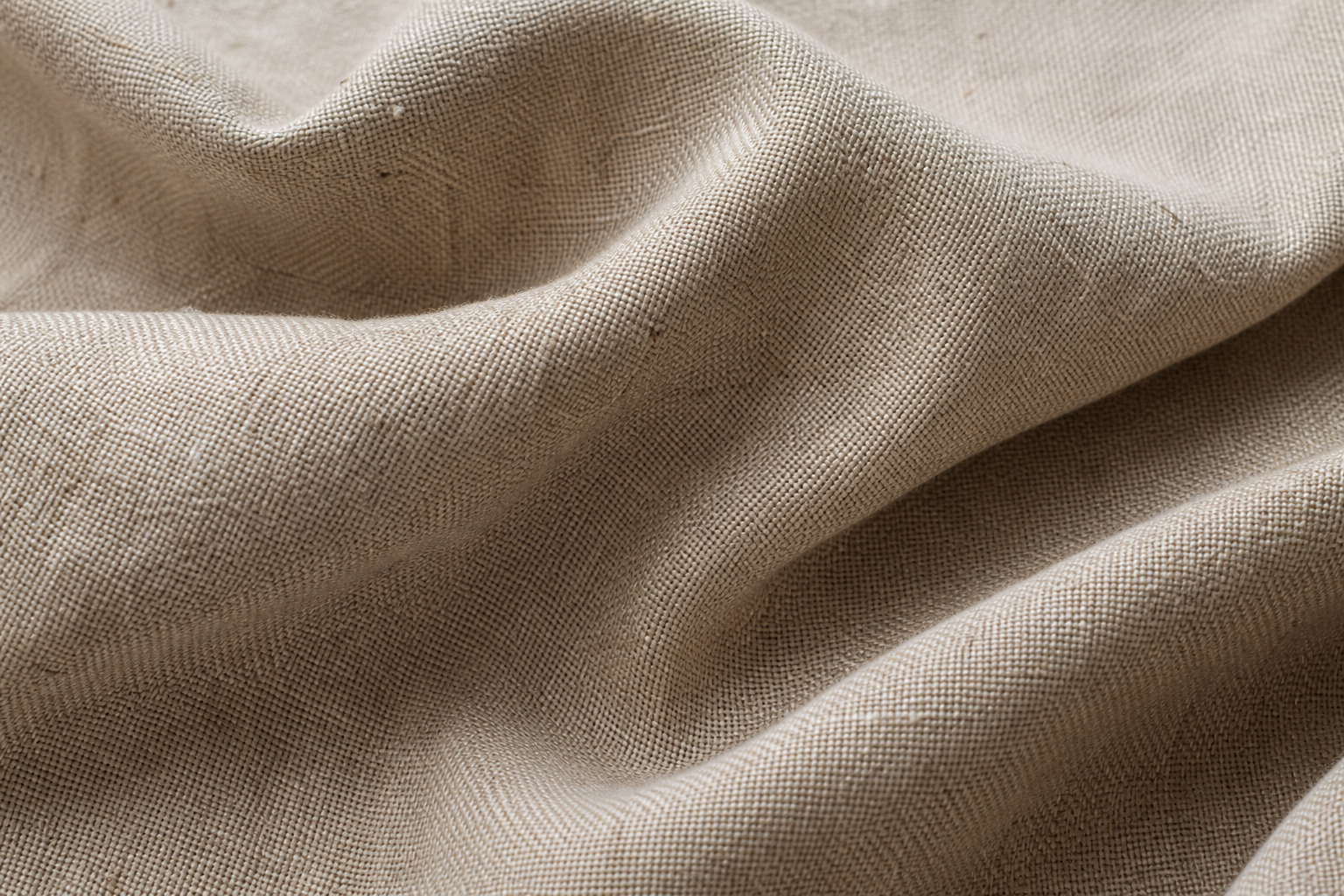 Close-up of natural flax linen tablecloth fabric showing its characteristic weave and slight slubs