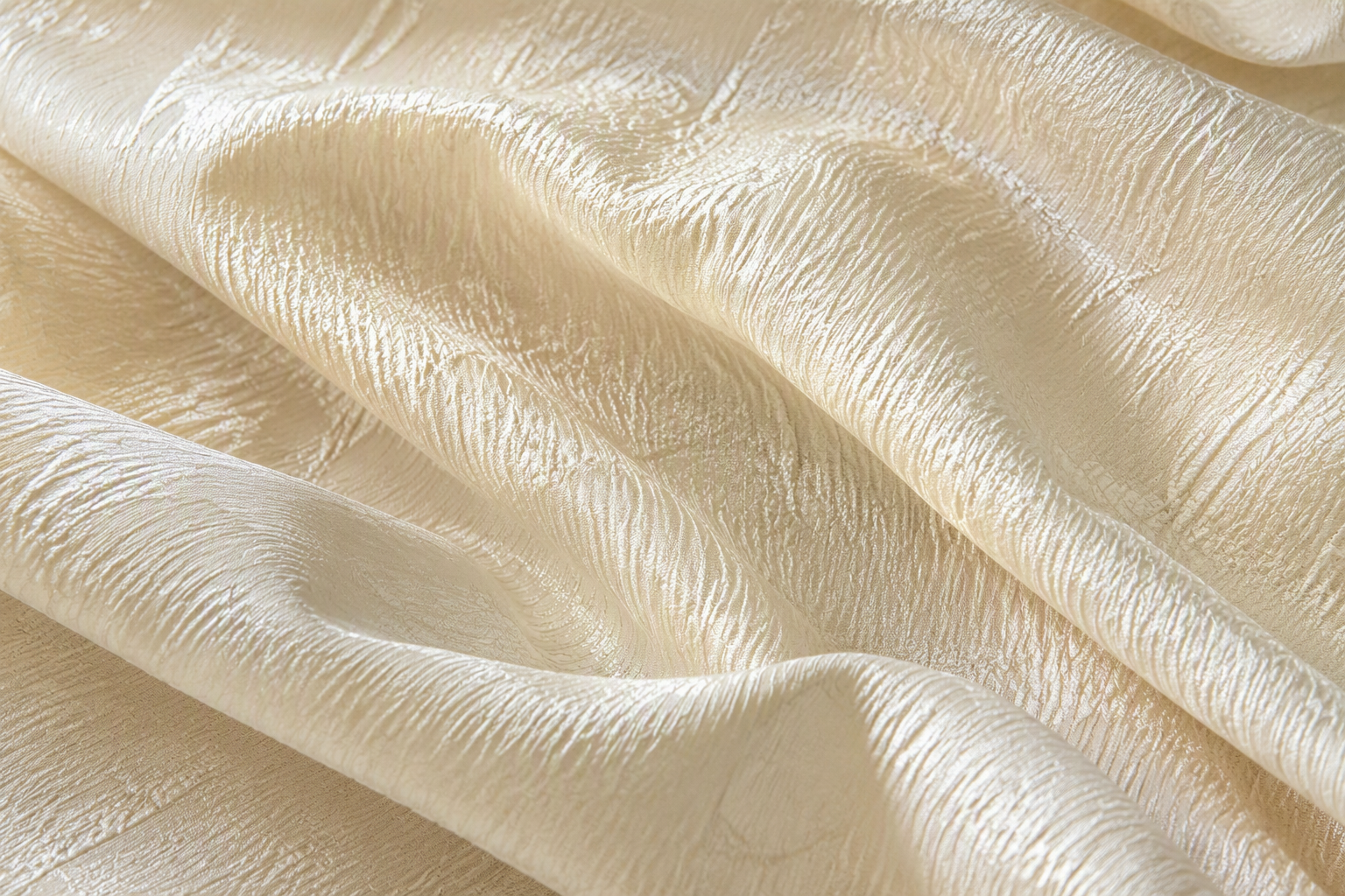 Macro close-up of wrinkled crepe taffeta fabric in ivory showing the fine crinkled surface
