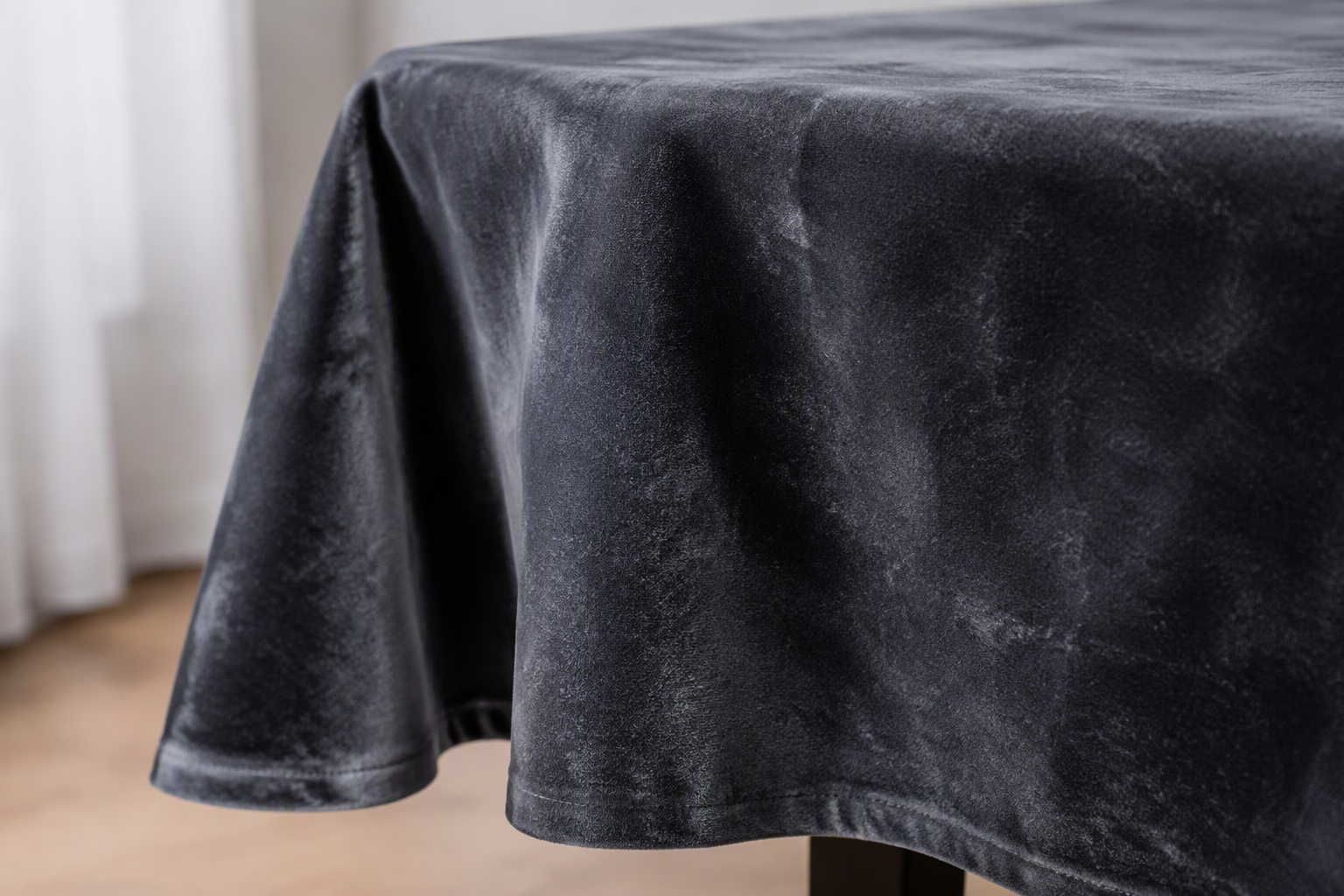 Charcoal velvet tablecloth draping over the edge of a table