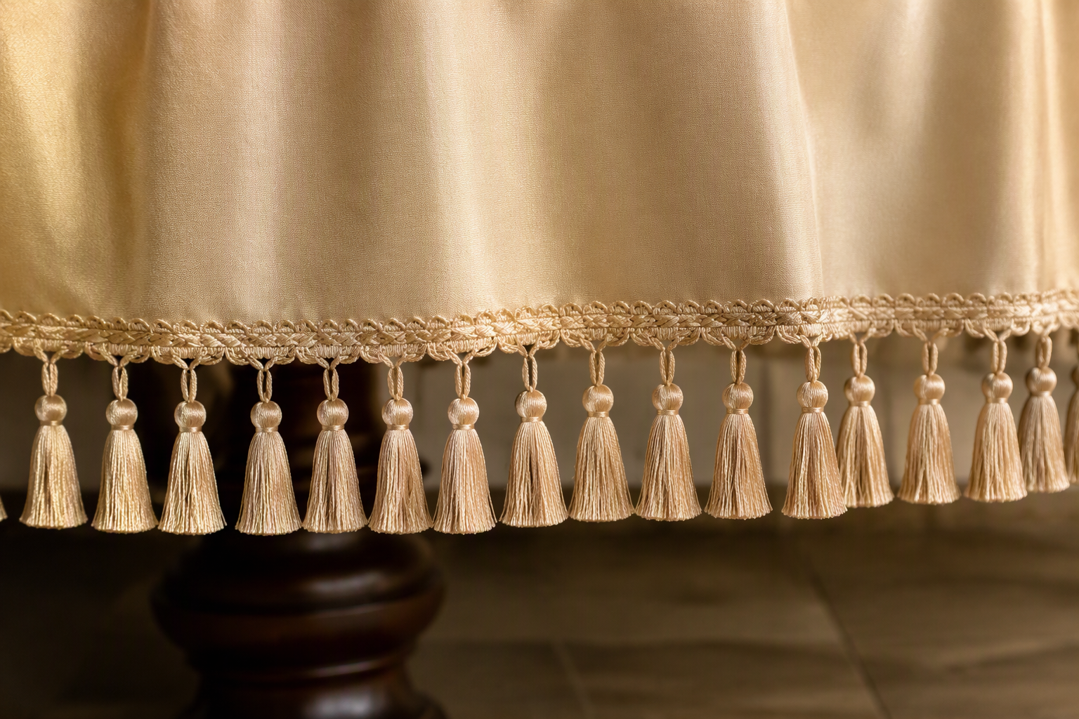 A tablecloth edge finished with an even decorative tassel fringe
