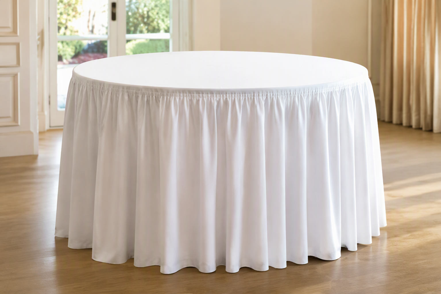 A round table with a long ruffled edge falling in soft even folds