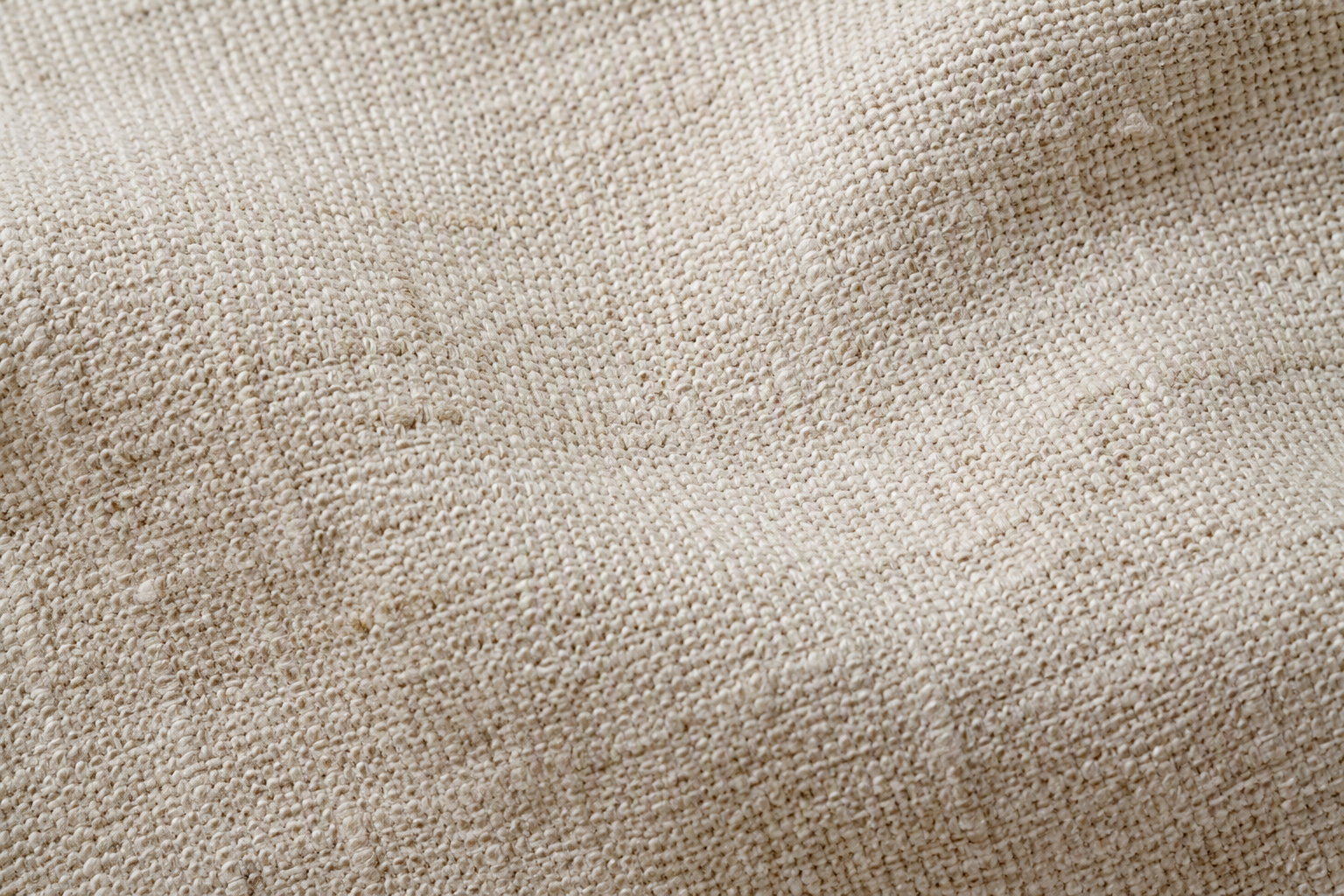 Macro of natural flax linen fabric showing irregular slub texture