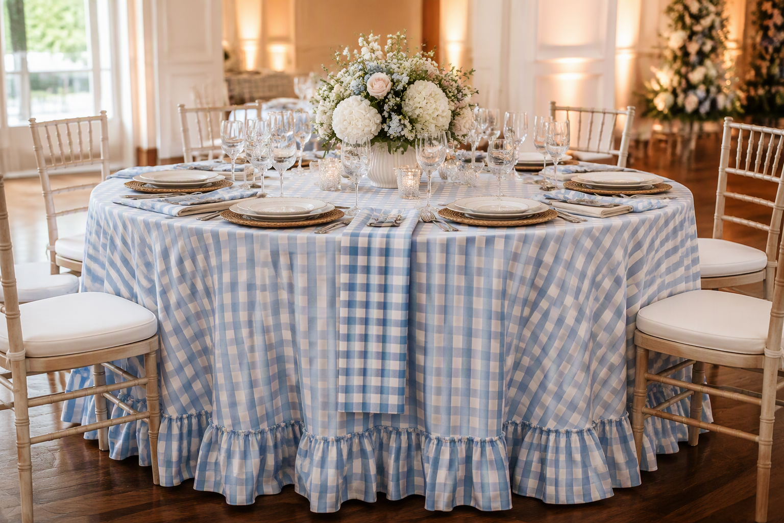 A round event table dressed with a gingham ruffle tablecloth and a matching gingham runner