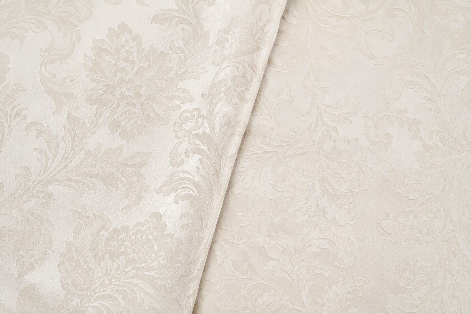 Two faces of damask fabric showing the motif reading in reverse